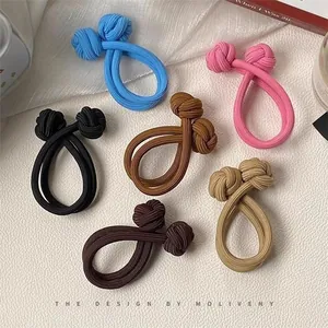 Set of six colorful elastic ribbed hair ties with double knot design on white texture
