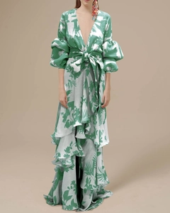Detail of green tropical print dress with deep V-neck, puff sleeves and layered ruffles