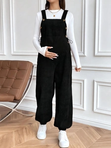 Loose black corduroy maternity overalls with adjustable waist and metal buttons design