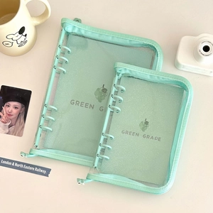 Detailed view of two green grape PVC binder covers with zipper and 6-ring mechanism