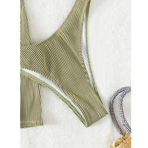 Close-up detail of light green ribbed bikini fabric with neat stitching and white lining