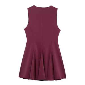Detail of burgundy sleeveless dress featuring a back invisible zipper and pleated hemline