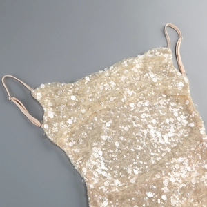 Close-up of champagne gold sequined evening dress straps and neckline detail
