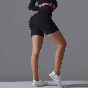 Detail showing high-waist seamless stitching and peach butt lifting effect on black biker shorts
