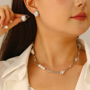 Baroque pearl necklace and earrings set worn by model with minimalist white shirt