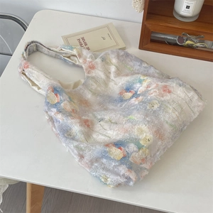 Detailed view of lace floral tote bag fabric on wooden table with lifestyle props