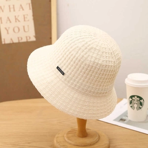 Creamy white waffle knit bucket hat for women featuring a warm wool-like texture