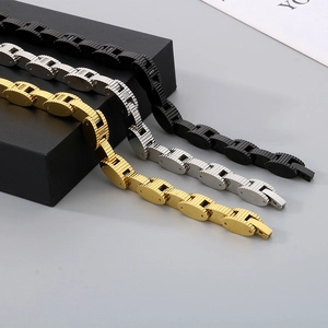 Detailed shot of stainless steel chain bracelets in black, silver and gold finishes