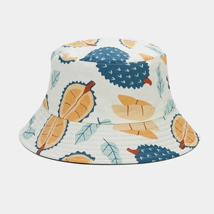 Detail of tropical durian print on white cotton bucket hat with blue and yellow accents
