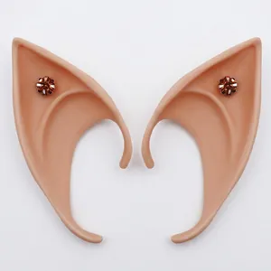 Detail view of pointed latex elf ears with bronze flower gemstone decor for cosplay