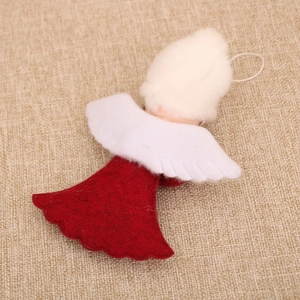 Detail of red and white felt angel ornament with wings on beige linen background