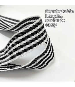 Detail of comfortable black and white striped woven handle with dense texture on tote bag