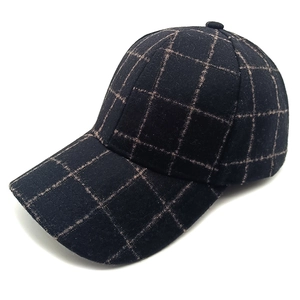 Side view of black plaid wool baseball cap with fine light brown check pattern detail