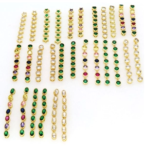 Macro shot of assorted colorful zircon earrings in gold settings with geometric shapes