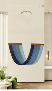 Detailed close-up of handmade gradient blue macrame fringe wall hanging with wooden rod