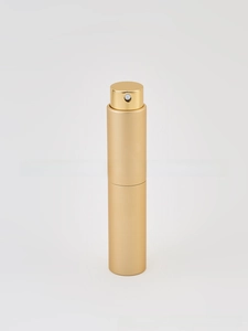 Close-up of the champagne gold metallic spray head and matte finish perfume atomizer bottle