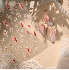 Macro shot of TL-455 floral nail stickers with butterfly patterns and pearl accents