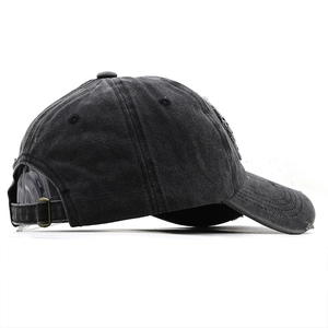 Detail of vintage washed cotton baseball cap showing side profile and frayed edge texture
