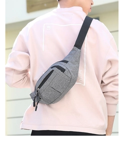 Close-up of grey sports waist bag showing multi-pocket design and durable fabric texture