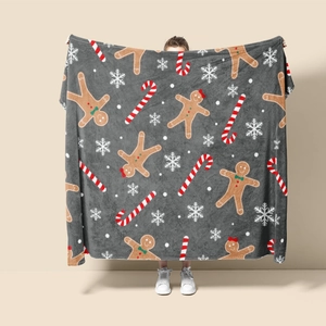Detail of Christmas flannel blanket with gingerbread man, candy cane and snowflake pattern
