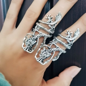 Detailed view of two silver dragon rings with intricate scales on a male hand