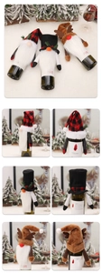 Detailed view of three Christmas gnome wine bottle covers with plaid hats and reindeer antlers