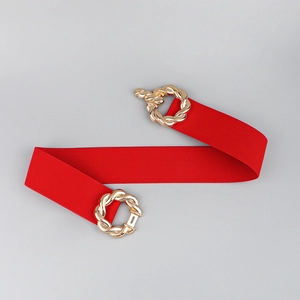 Detail of red elastic waist belt with an elegant gold interlocking buckle for coat