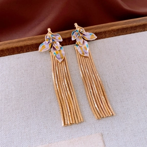 Detail of vintage enamel leaf earrings with sparkling rhinestones and golden tassels