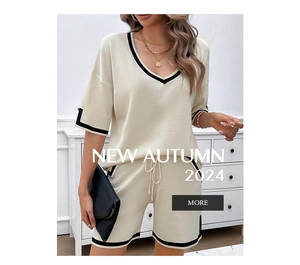 Detail of cream knit set featuring V-neck top and drawstring shorts with black trim