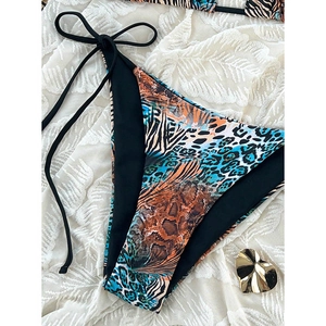 Detail of leopard and zebra print bikini bottom with adjustable black side ties