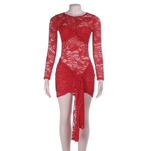 Detail of red lace mini dress featuring intricate cutout patterns and knot decorations