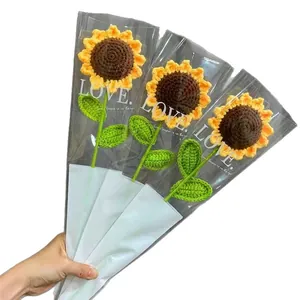 Three handmade crochet sunflowers in gift packaging, perfect for DIY knitted floral bouquets