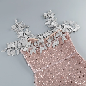 Detail of sequin embroidery and 3D silver leaf appliques on off-shoulder dress
