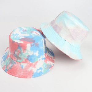 Close-up of tie-dye bucket hats in red, blue, and purple marble patterns with twill texture