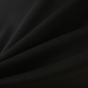 Close-up of black breathable mesh polo shirt fabric showing texture and micro pores