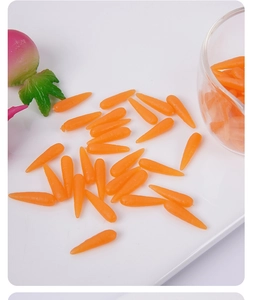 Detailed close-up of 1.8cm miniature resin carrots in a white tray for DIY crafts
