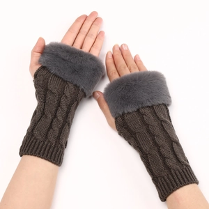 Close-up of knit fingerless gloves with dark brown twist pattern and grey faux fur trim