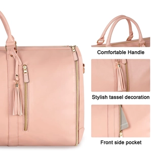 Detail of pink leather travel bag with tassels, dual handles, and side zipper pocket