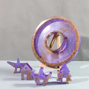 Detailed view of purple resin craft set with gold foil leaf in various artistic shapes