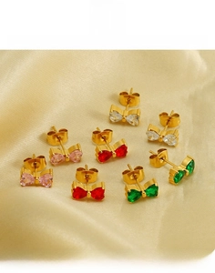 Macro shot of 18K gold plated bow earrings featuring colorful heart-shaped cubic zirconia
