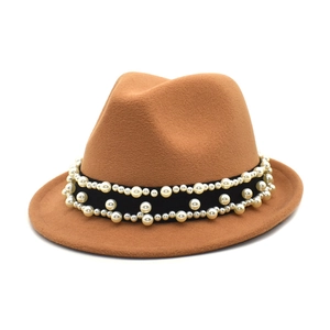 Detail of a brown wool fedora hat featuring a black band decorated with white pearls