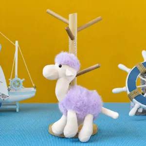 Detailed macro view of a cute purple and white plush camel keychain with a bead chain.