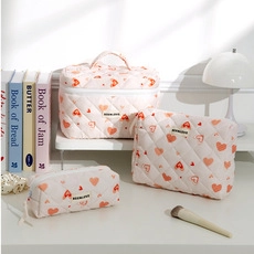 Three-piece quilted makeup bag set with heart patterns for cosmetic storage