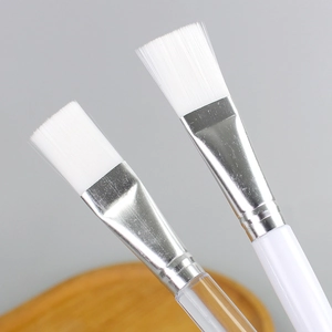 Set of two crystal mask brushes with white bristles and transparent handles for DIY mud masks