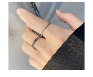 Gros plan de bagues en argent minimalistes ornées de zircons blancs et violets