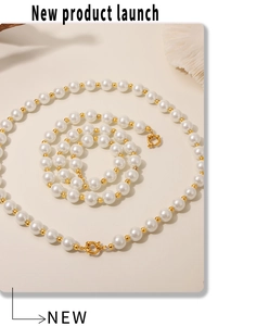 Detailed shot of 12mm shell pearl necklace with gold metal beads and lobster clasp