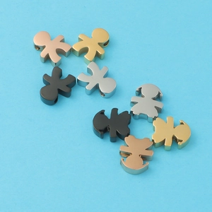 Polished metal human-shaped charms in gold, silver, black and rose gold on blue background