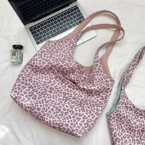 Detailed top view of leopard print tote bag with pocket showing pink animal pattern fabric