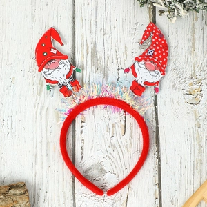 Detailed view of plush Christmas headband with Santa motifs and festive red sequins