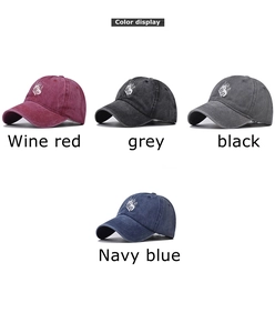 Detail showing vintage washed cotton baseball caps in burgundy, grey, black, and navy blue